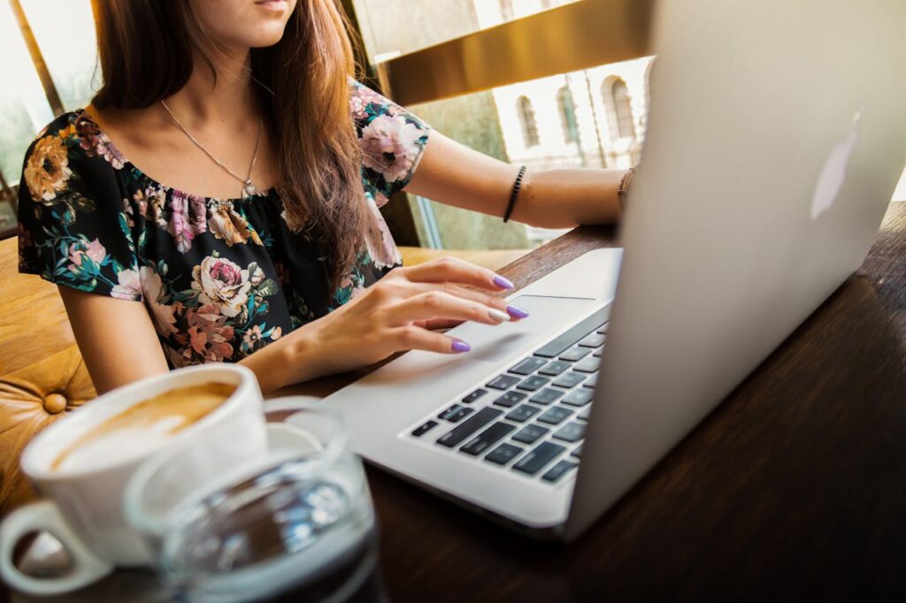 woman-wearings-coop-neck-floral-top-using-her-apple-brand-macbook-144230 Woman Wearings Coop Neck Floral Top Using Her Apple Brand Macbook